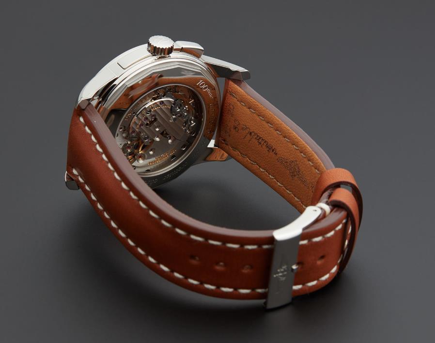 The stainless steel fake watch has a brown strap.